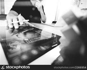 creative hand working digital tablet and wood puzzle with laptop computer and tablet computer as design concept,black and white