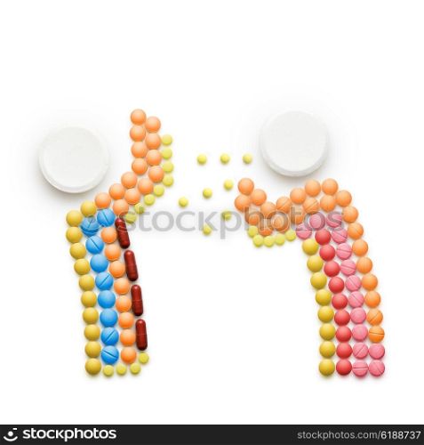Creative health concept made of drugs and pills, isolated on white. A person that caught a cold, sneezing and spreading disease on another person.