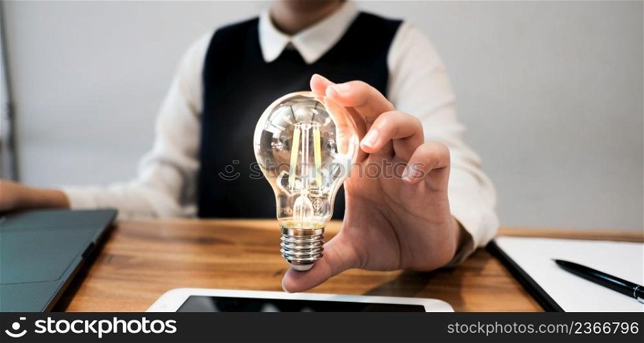 Creative idea Business women holding light bulbs Concept of idea technology and creativity.