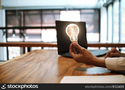 Creative idea Business women holding light bulbs Concept of idea technology and creativity.