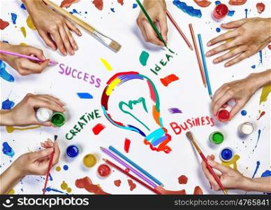Creative idea for your business. Top view of hands drawing business creative concept with paints
