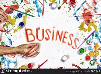 Creative ideas for your business. Top view of hands drawing business creative concept with paints