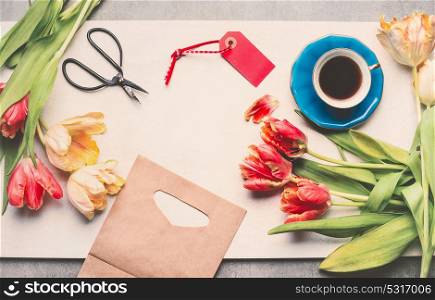 Creative layout with spring tulips, cup of coffee, scissors, tag and shopping bag, top view