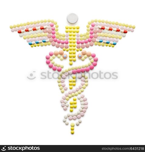 Creative medicine and healthcare concept made of drugs and pills, isolated on white. Caduceus medical symbol and symbol of commerce featuring intertwined snakes around a winged rod.