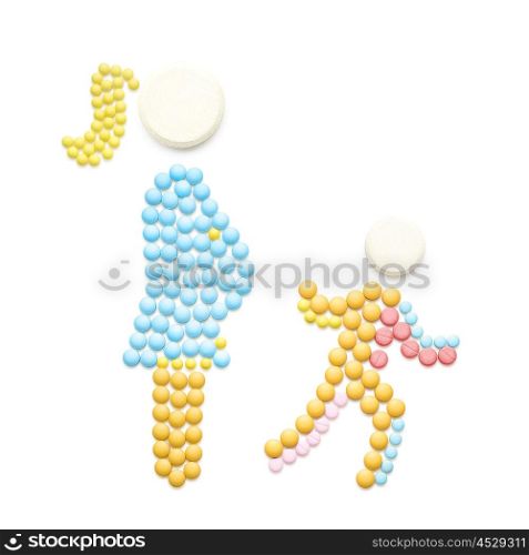 Creative medicine and healthcare concept made of pills, pregnant with IVF baby mother walking with another child, isolated on white.