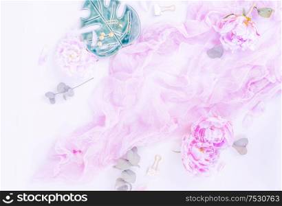 Creative moern wedding composition mock up, pink blanket, flowers, eucalyptus branches on white desk background. Flat lay, top view stylish art concept, toned. Creative wedding composition