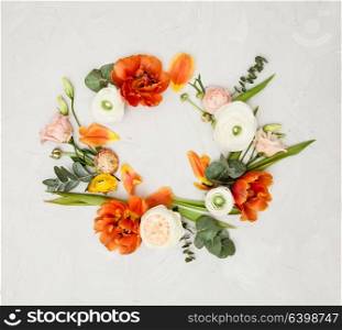 Creative orange and beige flowers flat lay frame for design. Floral design space