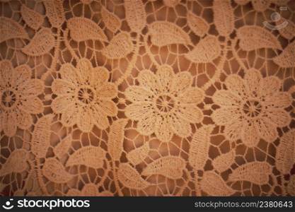 Creative pattern design made of handmade crochet on brown background.