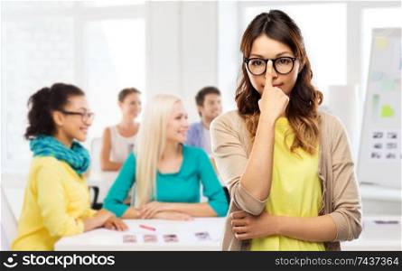 creative people, occupation and education concept - asian woman in glasses or student over design studio background. asian woman in glasses or student