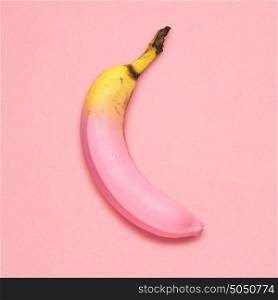 Creative photo of a painted banana on pink background.