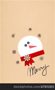 Creative photo of a snowman mad of paper on brown background.