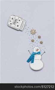 Creative photo of a snowman made of paper on grey background.