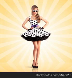 Creative photo of a vogue pin-up girl, dressed in a retro polka-dot dress and sunglasses, posing on colorful abstract cartoon style background.