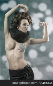 creative portrait of splendid female with brown cute hair-style, collar fur and some glittering pieces of mirrors on her visage and body