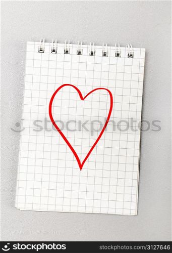 creative process. notebook with heart picture on gray