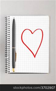 creative process. notebook with heart picture on gray