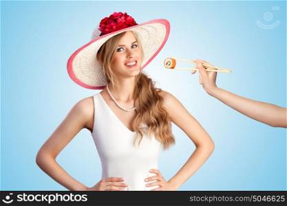 Creative retro photo of a young sexy girl wearing a cartwheel hat, eating sushi from chopsticks.
