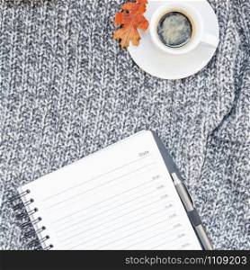 Creative square autumn flat lay overhead top view stylish home workspace planner organizer coffee cup cozy gray knitted plaid background copy space. Fall season template for feminine blog social media