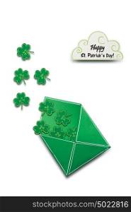 Creative St. Patricks Day concept photo of a shamrock in an envelope made of paper on white background.