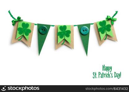 Creative St. Patricks Day concept photo of flags with shamrocks made of paper on white background.