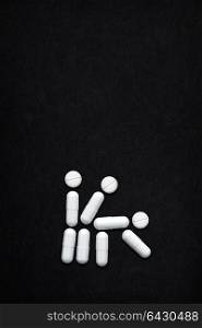 Creative still life of AIDS transmission via multiple sex partners; medicine concept made of drugs and pills.