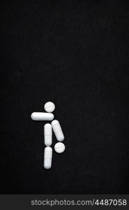 Creative still life of AIDS transmission via standing 69 oral sex position; medicine concept made of drugs and pills.