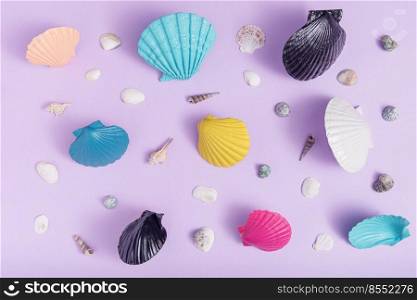 Creative summer pattern with colorful sea shells on a purple background. Rectangle layout. Flat lay, top view. Creative summer pattern with colorful sea shells on a purple background