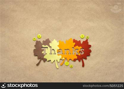 Creative thanksgiving day concept photo of leaves made of paper on brown background.
