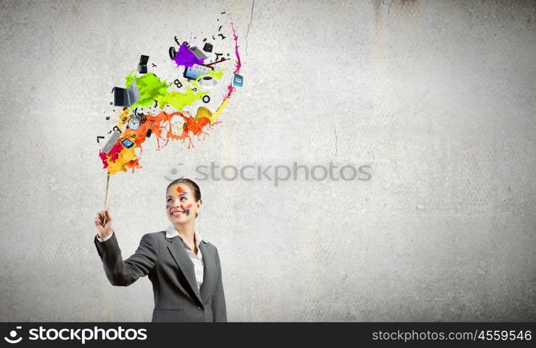 Creative thinking. Young attractive businesswoman with paint brush in hand