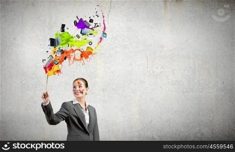 Creative thinking. Young attractive businesswoman with paint brush in hand