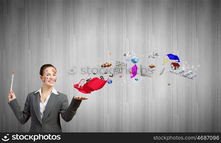 Creative thinking. Young attractive businesswoman with paint brush in hand