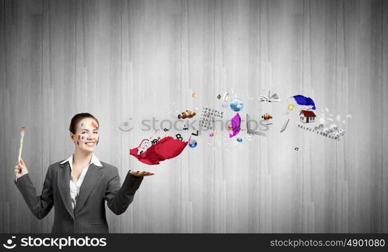 Creative thinking. Young attractive businesswoman with paint brush in hand