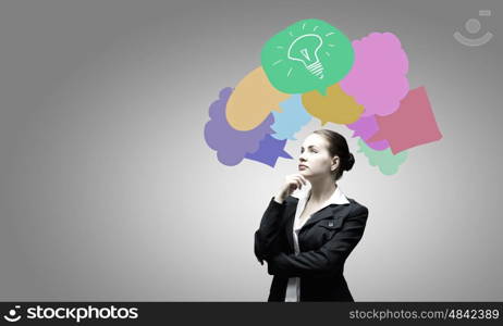 Creative thinking. Young attractive woman and colorful thoughts above her head