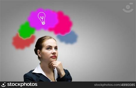 Creative thinking. Young attractive woman and colorful thoughts above her head