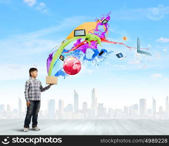 Creative thinking. Young boy splashing colorful paint from bucket