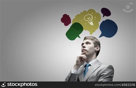 Creative thinking. Young businessman and colorful thoughts above her head