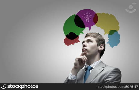 Creative thinking. Young businessman and colorful thoughts above her head