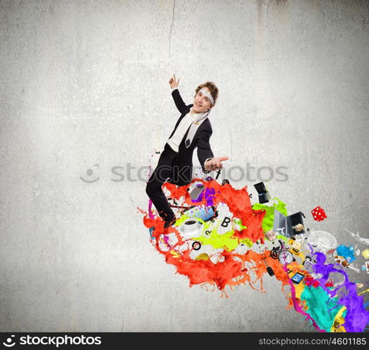 Creative thinking. Young cheerful businessman with tie around head