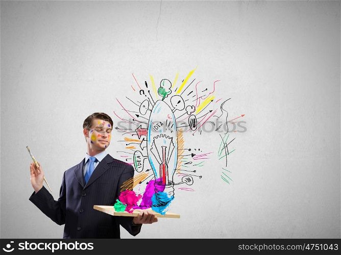 Creative thinking. Young handsome businessman with brush in hand