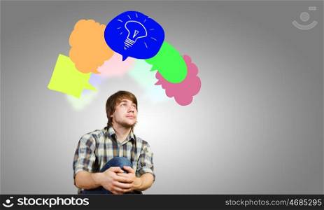 Creative thinking. Young man and colorful thoughts above her head