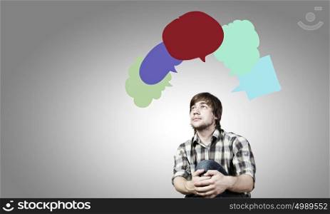 Creative thinking. Young man and colorful thoughts above her head