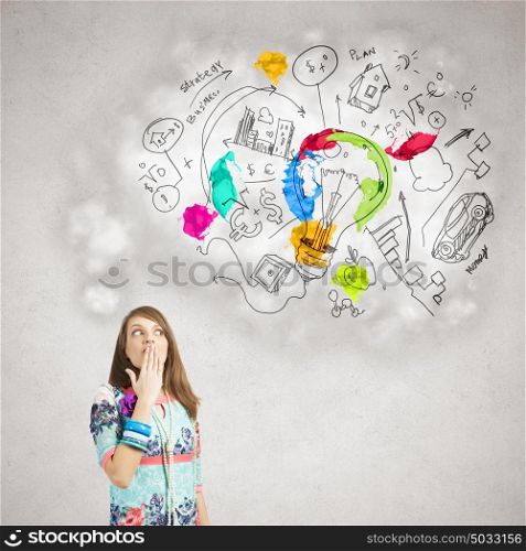 Creative thinking. Young surprised woman and business colorful sketches