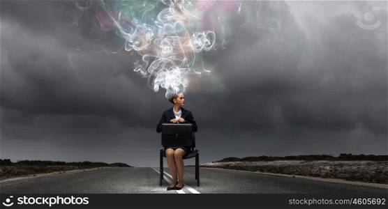 Creative thinking. Young thoughtful confused businesswoman sitting on chair