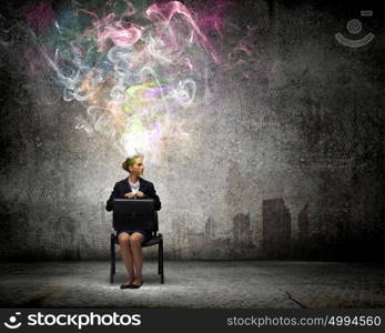 Creative thinking. Young thoughtful confused businesswoman sitting on chair