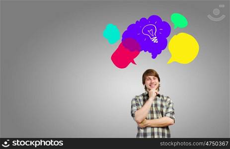 Creative thinking. Young thoughtful man and colorful speech bubbles above