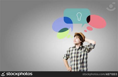 Creative thinking. Young thoughtful man and colorful speech bubbles above