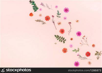 Creative Top view flat lay autumn composition. Frame made of dried flowers and leaves on color paper background with copy space. Template for fall harvest wedding anniversary invitation cards