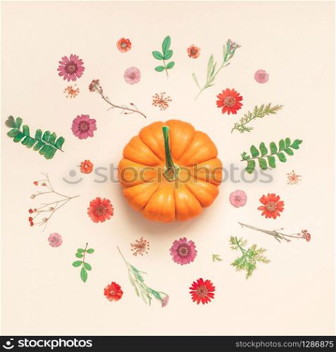 Creative Top view flat lay autumn composition. Pumpkins dried flowers leaves color paper background copy space. Square Template fall harvest thanksgiving halloween anniversary invitation cards