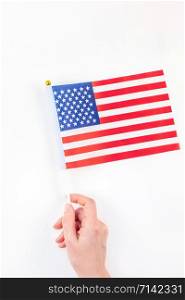 Creative top view flat lay of American flags for Elections, Memorial Day, 4th of July or Labour Day with copy space on white background in minimal style. Concept of patriotism and independence