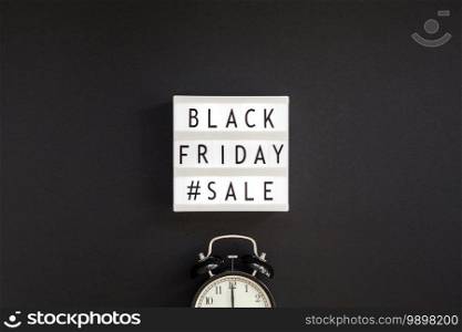 Creative Top view flat lay promotion composition Black friday sale text on lightbox alarm clock black background copy space Template Black friday sale mockup fall thanksgiving promotion advertising